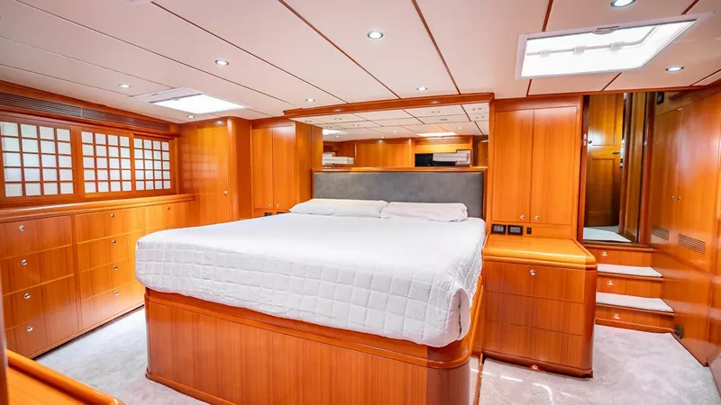 Take 5 Yacht Photos Pics Luxurious wooden interior of 2009 Nordhavn 76 yacht bedroom with large bed.