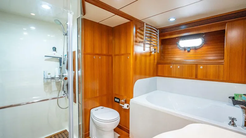 Take 5 Yacht Photos Pics Luxurious bathroom in 2009 Nordhavn 76 yacht with wood paneling, shower, and bathtub.