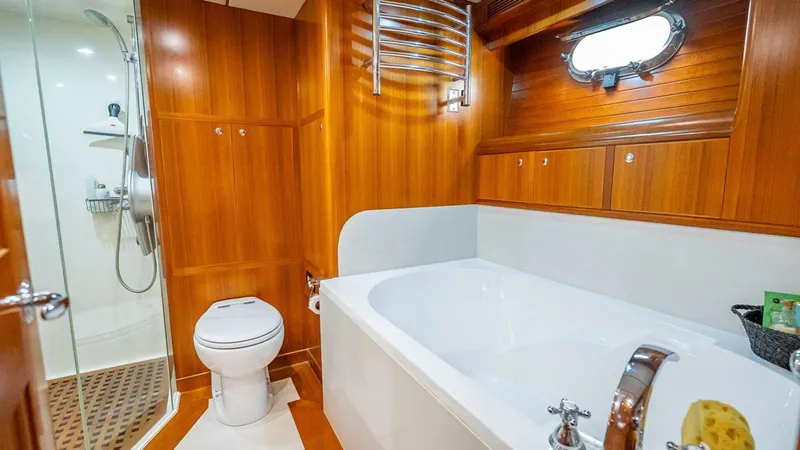 Take 5 Yacht Photos Pics Luxurious bathroom in 2009 Nordhavn 76 yacht with wood paneling and modern fixtures.