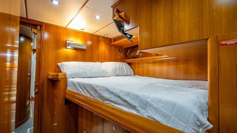 Take 5 Yacht Photos Pics Luxurious wooden cabin interior of 2009 Nordhavn 76 yacht with cozy bed.