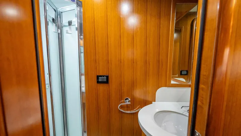 Take 5 Yacht Photos Pics Luxurious bathroom in 2009 Nordhavn 76 yacht with wooden paneling and modern fixtures.