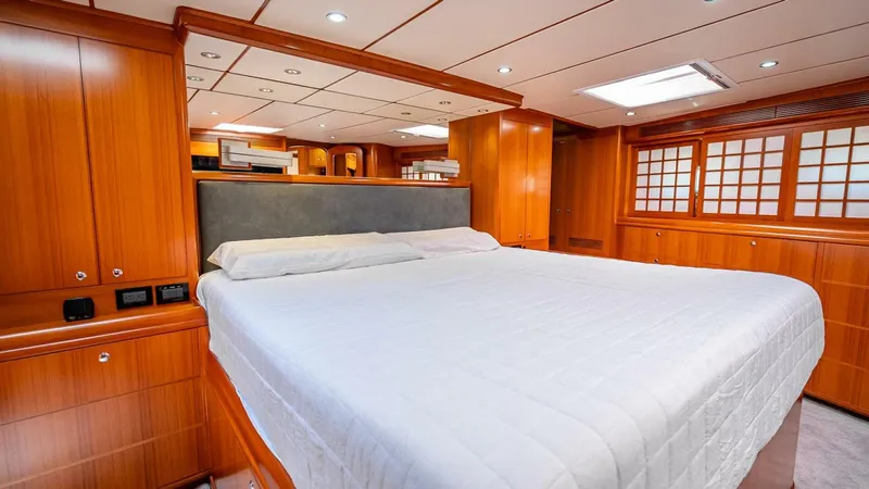 Take 5 Yacht Photos Pics Luxurious cabin interior of 2009 Nordhavn 76 yacht with wood paneling and spacious bed.