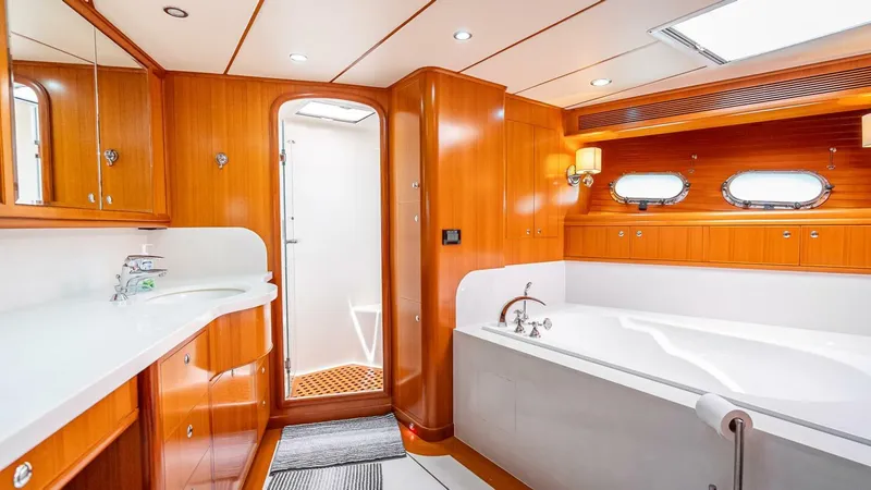 Take 5 Yacht Photos Pics Luxurious bathroom in 2009 Nordhavn 76 yacht with wood paneling and modern fixtures.