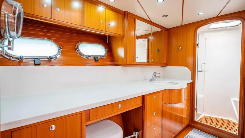 Take 5 Yacht Photos Pics Luxurious bathroom interior of 2009 Nordhavn 76 yacht with wooden cabinetry and modern fixtures.
