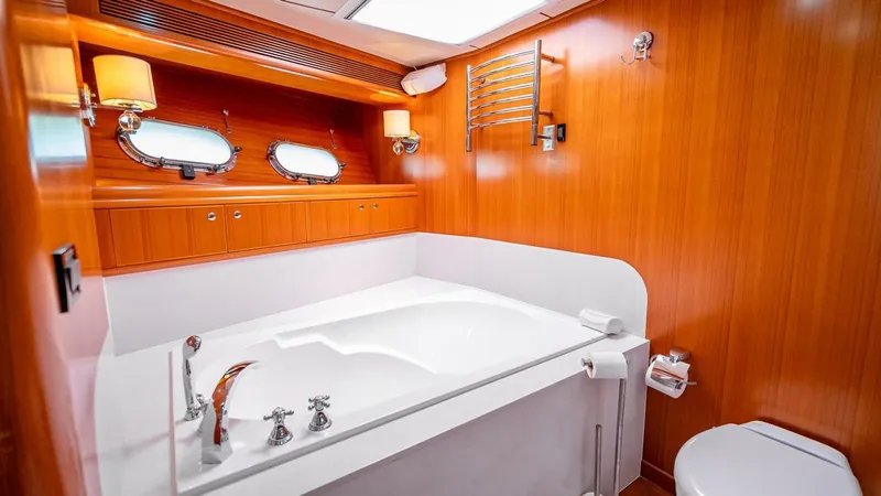 Take 5 Yacht Photos Pics Luxurious bathroom in 2009 Nordhavn 76 yacht with wood paneling and modern fixtures.