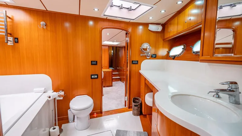 Take 5 Yacht Photos Pics Luxurious bathroom in 2009 Nordhavn 76 yacht with wooden cabinetry and modern fixtures.