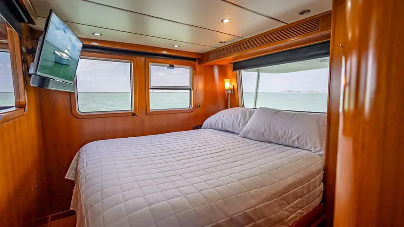 Take 5 Yacht Photos Pics Luxurious cabin interior of 2009 Nordhavn 76 yacht with ocean view and cozy bed.