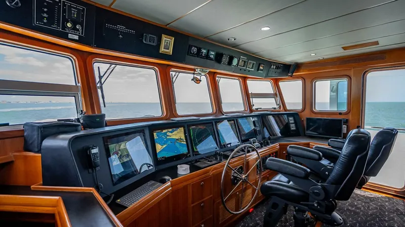 Take 5 Yacht Photos Pics Pilothouse of 2009 Nordhavn 76 yacht with navigation screens and ocean view.