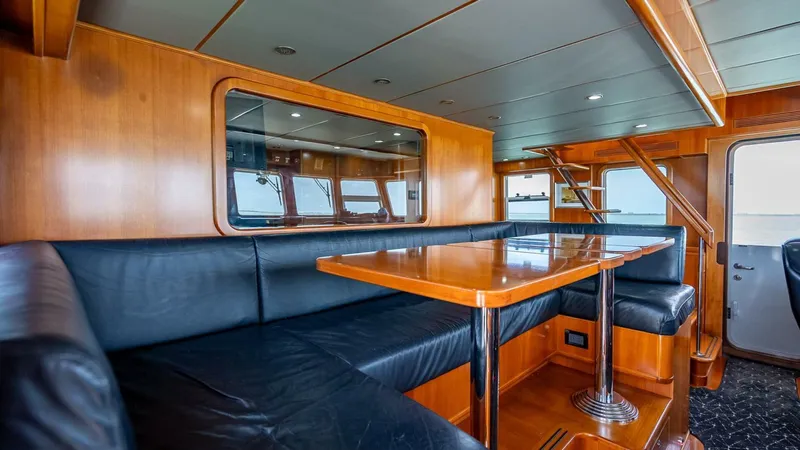 Take 5 Yacht Photos Pics Luxurious interior of 2009 Nordhavn 76 yacht with wood paneling and leather seating.