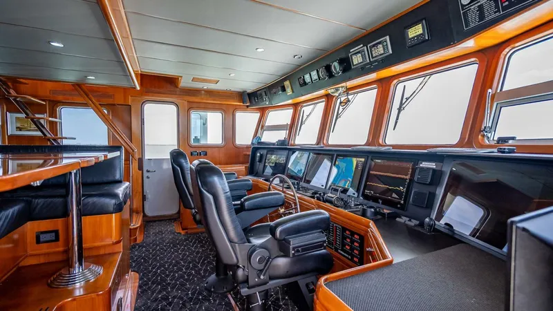 Take 5 Yacht Photos Pics Pilothouse of 2009 Nordhavn 76 yacht with advanced navigation equipment and luxurious seating.