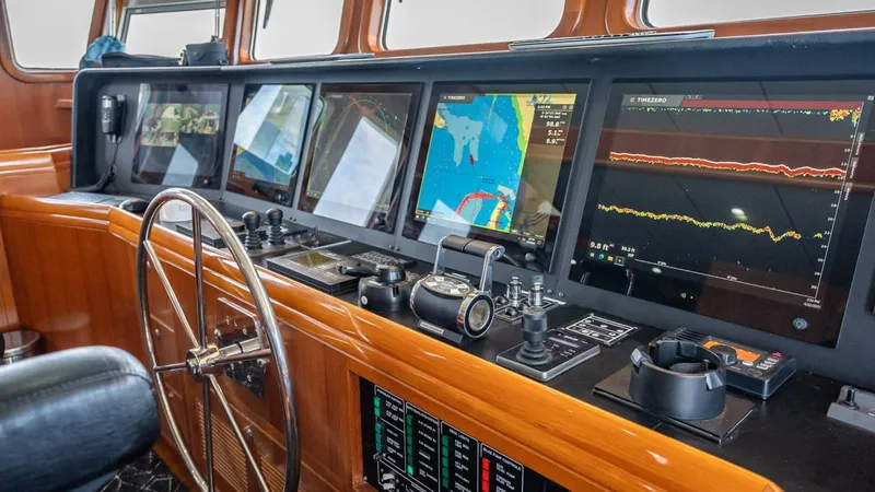 Take 5 Yacht Photos Pics Navigation console of 2009 Nordhavn 76 yacht with multiple screens and controls.