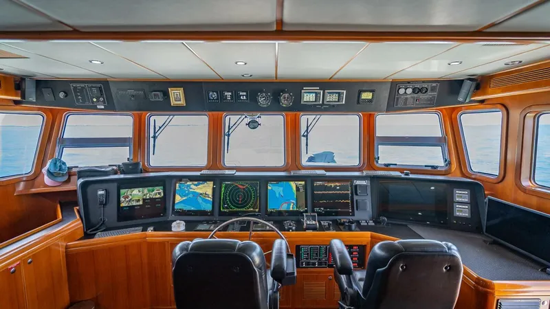 Take 5 Yacht Photos Pics Pilothouse of 2009 Nordhavn 76 yacht with navigation equipment and ocean view.