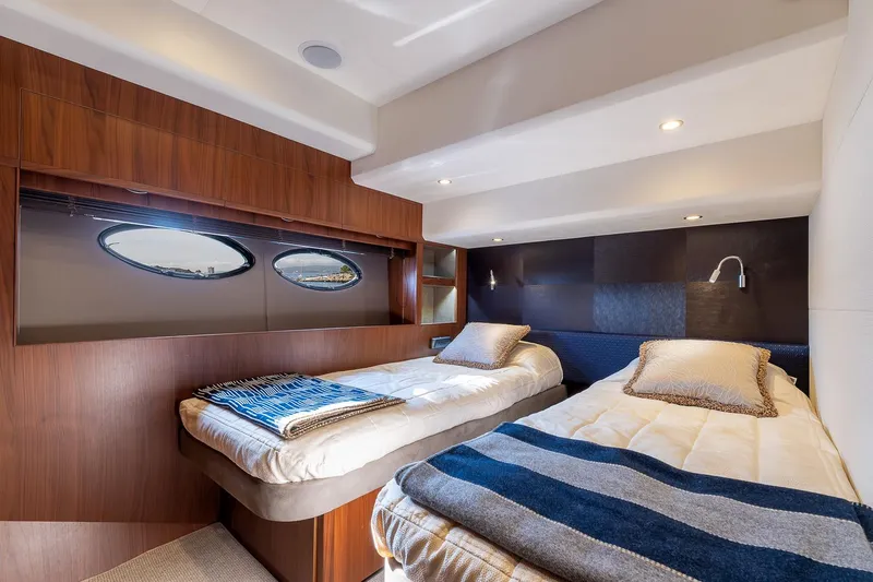  Yacht Photos Pics Luxurious cabin interior of 2014 Princess 72 Motor Yacht with twin beds and elegant wood finish.