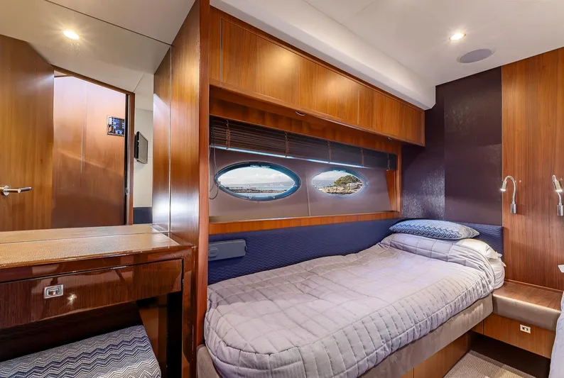  Yacht Photos Pics Luxurious cabin interior of 2014 Princess 72 Motor Yacht with wood finishes and cozy bedding.