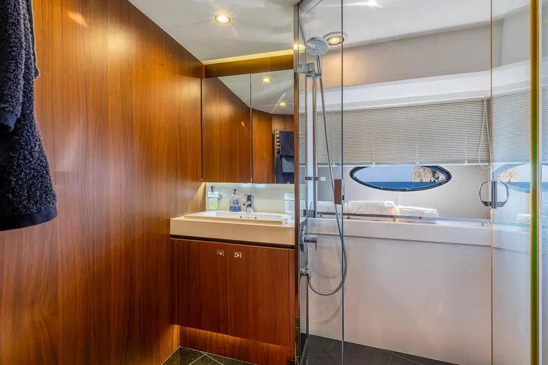  Yacht Photos Pics Luxurious bathroom in 2014 Princess 72 Motor Yacht with wood paneling and modern fixtures.