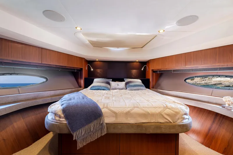  Yacht Photos Pics Luxurious bedroom interior of 2014 Princess 72 Motor Yacht with elegant wood finishes.