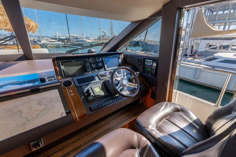  Yacht Photos Pics Helm of 2014 Princess 72 Motor Yacht with leather seats and navigation equipment.