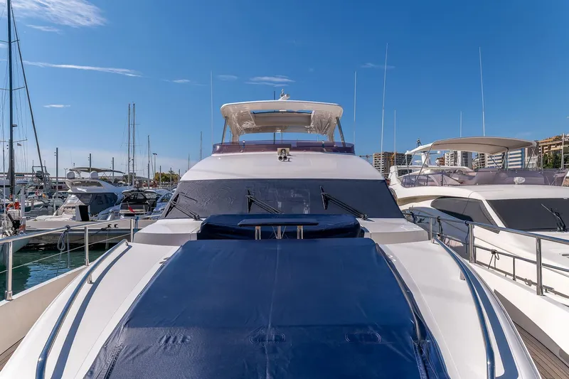  Yacht Photos Pics 2014 Princess 72 Motor Yacht docked in marina under clear blue sky.
