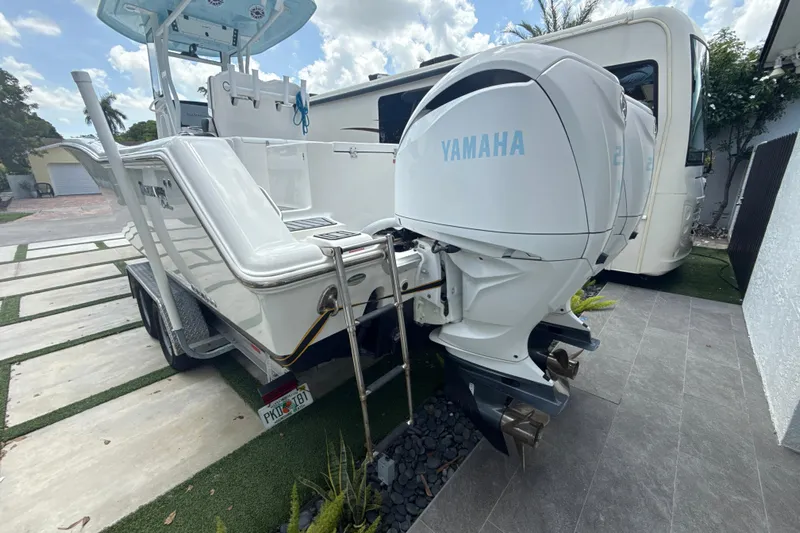  Yacht Photos Pics 2022 Tidewater 280 CC Adventure boat with dual Yamaha outboard engines, parked on a trailer.