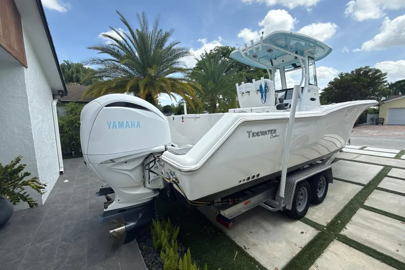  Yacht Photos Pics 2022 Tidewater 280 CC Adventure boat with Yamaha engine on trailer, parked outdoors.