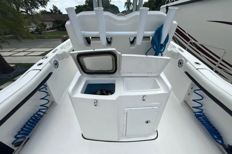  Yacht Photos Pics 2022 Tidewater 280 CC Adventure boat deck with storage compartments and rod holders.