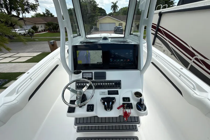  Yacht Photos Pics 2022 Tidewater 280 CC Adventure boat helm with modern navigation and control systems.