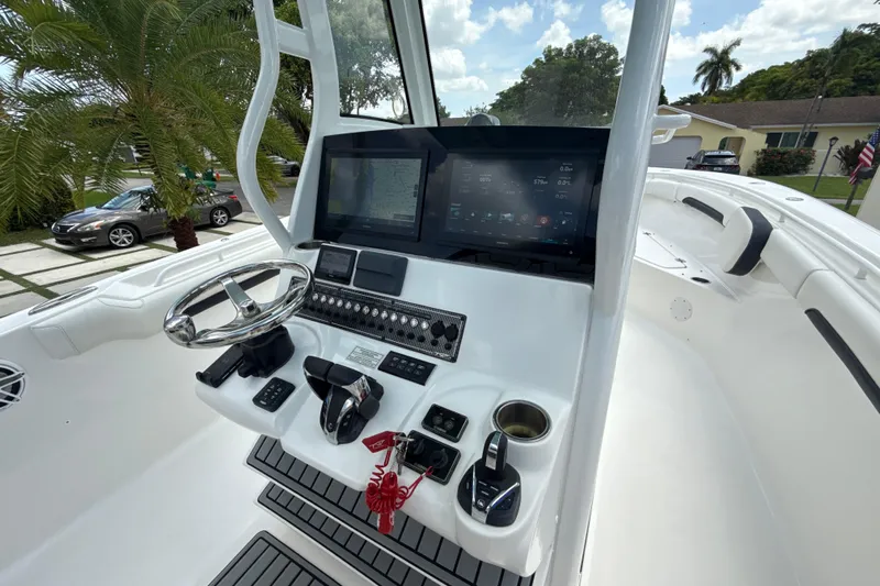  Yacht Photos Pics 2022 Tidewater 280 CC Adventure boat helm with modern controls and navigation display.