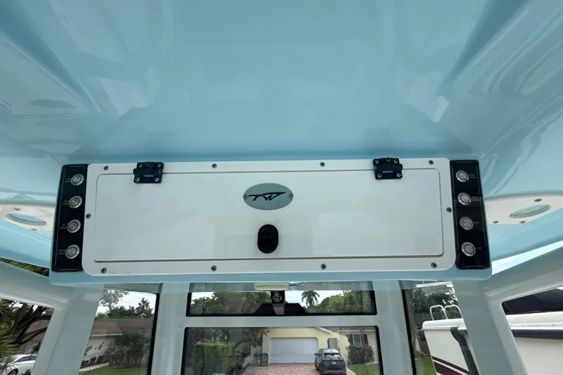  Yacht Photos Pics 2022 Tidewater 280 CC Adventure boat console with control panel and storage compartment.