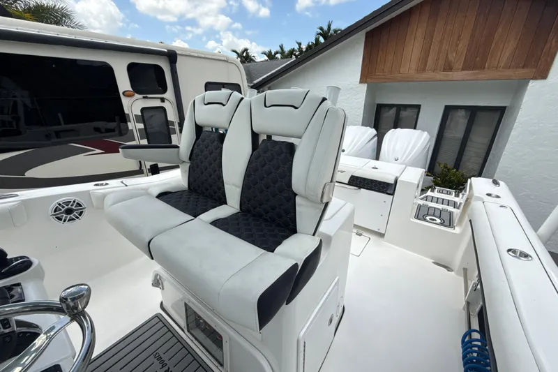  Yacht Photos Pics 2022 Tidewater 280 CC Adventure boat interior with dual seats and modern design.
