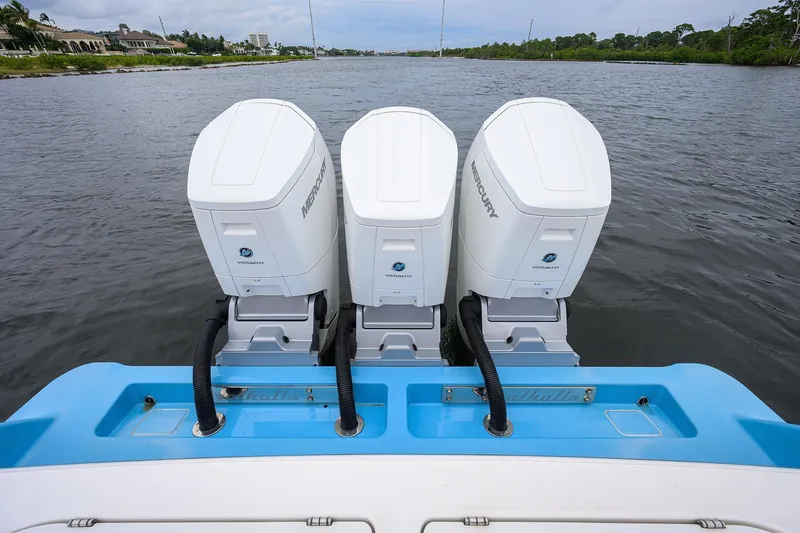 Patriot Yacht Photos Pics Triple Mercury outboard engines on 2023 Valhalla Boatworks vessel, cruising on a scenic waterway.