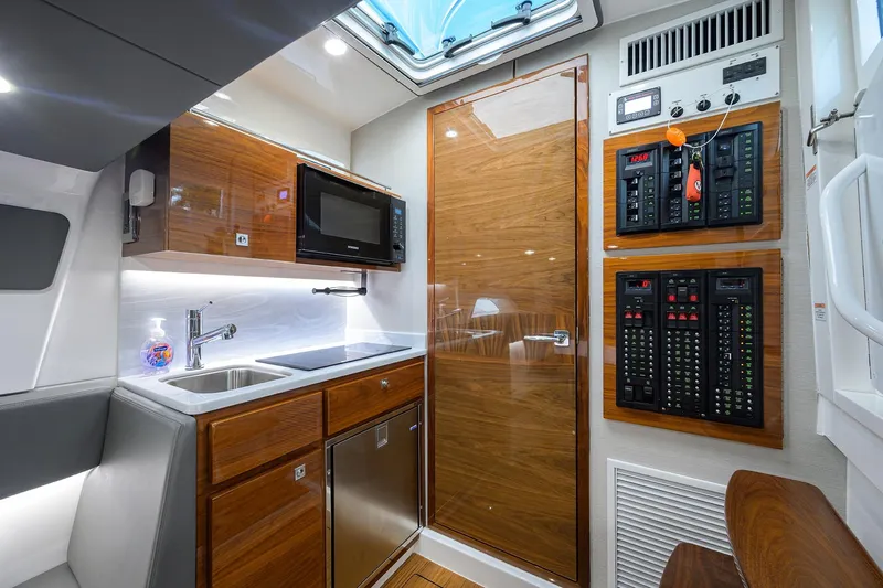 Patriot Yacht Photos Pics 2023 Valhalla Boatworks interior with modern kitchen, control panels, and wood finishes.