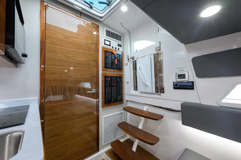 Patriot Yacht Photos Pics 2023 Valhalla Boatworks interior with wooden door, control panels, and modern design elements.