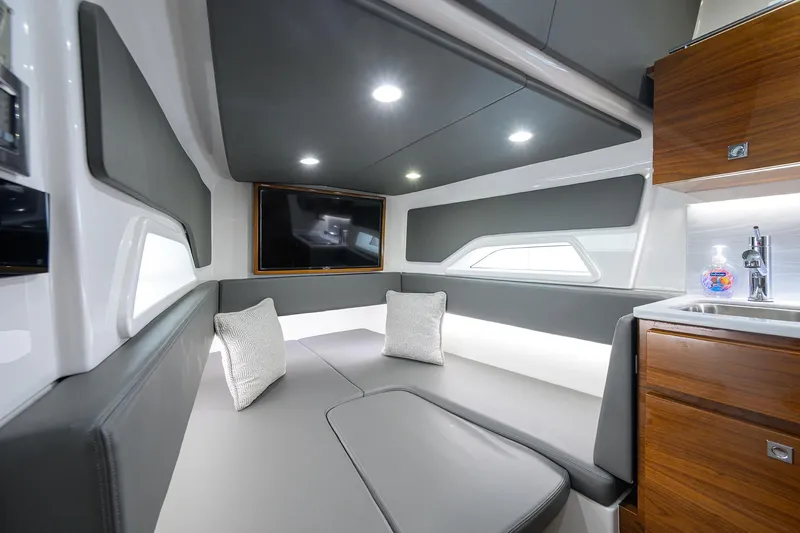 Patriot Yacht Photos Pics Luxurious 2023 Valhalla Boatworks interior with modern seating, TV, and kitchenette.