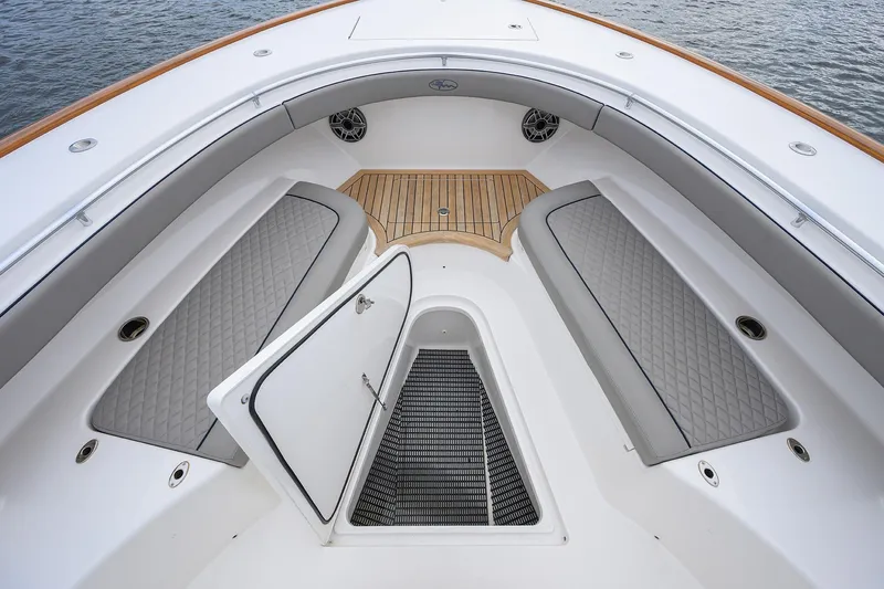 Patriot Yacht Photos Pics 2023 Valhalla Boatworks interior with open hatch, cushioned seating, and wooden deck accents.