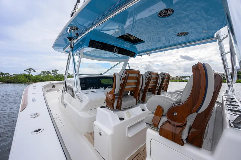 Patriot Yacht Photos Pics 2023 Valhalla Boatworks interior with luxurious seating and modern dashboard on a calm waterway.