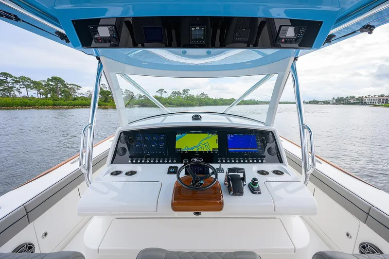 Patriot Yacht Photos Pics 2023 Valhalla Boatworks helm with advanced navigation systems on a serene waterway.