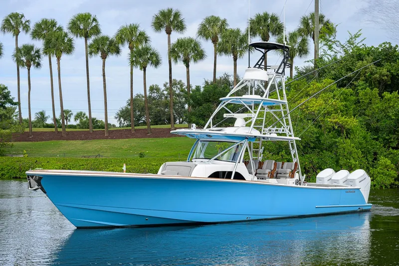 Patriot Yacht Photos Pics 2023 Valhalla Boatworks boat on water, surrounded by palm trees.