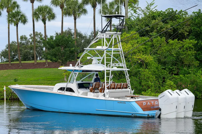 Patriot Yacht Photos Pics 2023 Valhalla Boatworks vessel with triple outboard engines, cruising on a scenic waterway.