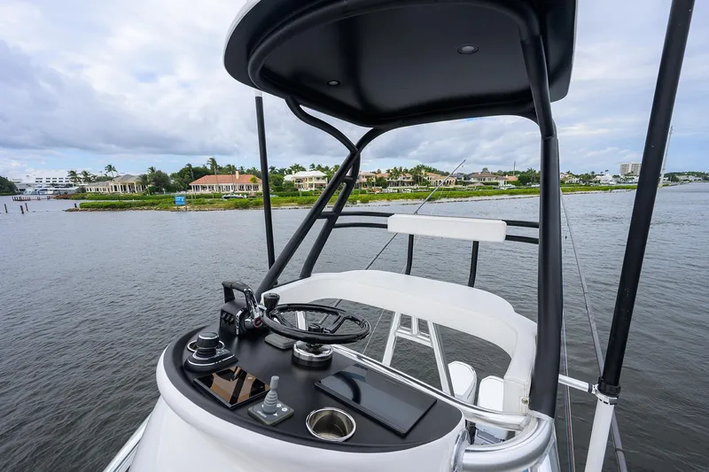 Patriot Yacht Photos Pics 2023 Valhalla Boatworks helm with scenic waterfront view, featuring modern controls and seating.