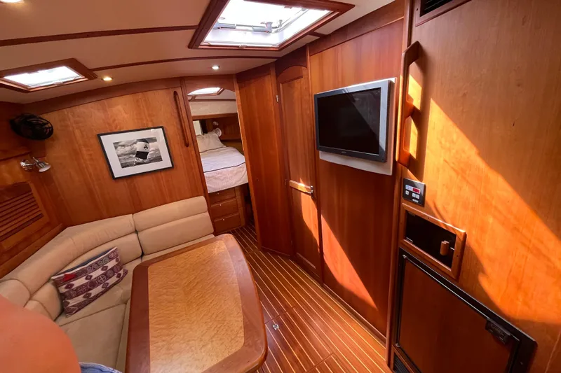 Shibumi Yacht Photos Pics Luxurious interior of 2004 Sabre 42 Hardtop Express yacht with wood paneling and cozy seating.
