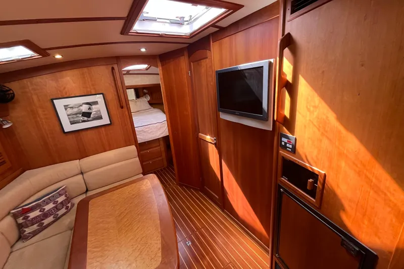 Shibumi Yacht Photos Pics Interior of 2004 Sabre 42 Hardtop Express yacht with wood paneling and cozy seating area.