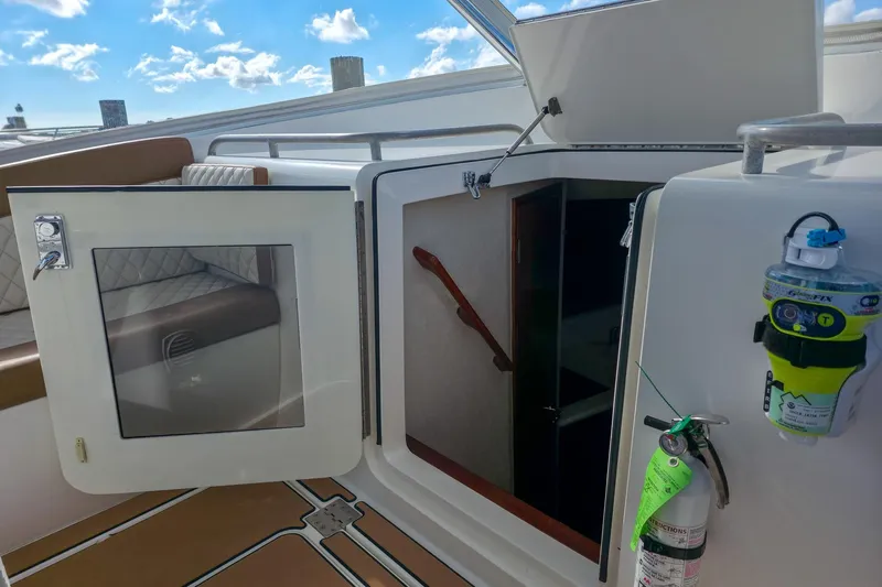  Yacht Photos Pics 2005 Buddy Davis 35' Express boat interior with open cabin door and safety equipment.
