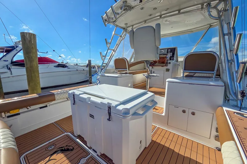  Yacht Photos Pics 2005 Buddy Davis 35' Express boat interior with seating and helm, docked under clear skies.