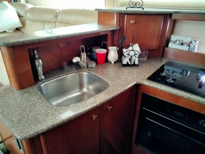 Sunshine Yacht Photos Pics 2005 Meridian 459 Motoryacht kitchen with sink, countertop, and stove.