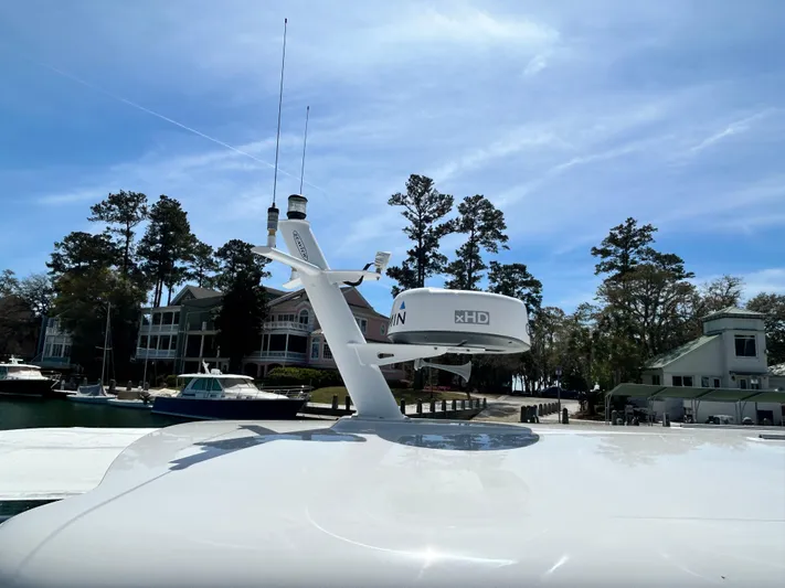  Yacht Photos Pics 2014 Back Cove Downeast 37 yacht with radar, docked near waterfront homes.