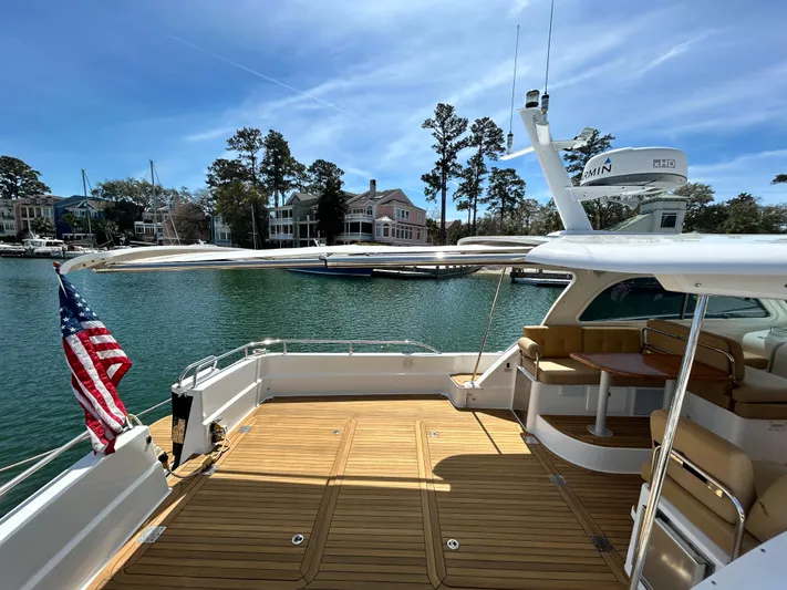  Yacht Photos Pics 2014 Back Cove Downeast 37 yacht with teak deck, docked by waterfront homes.