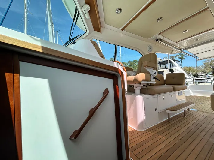  Yacht Photos Pics 2014 Back Cove Downeast 37 interior with wood accents and seating.