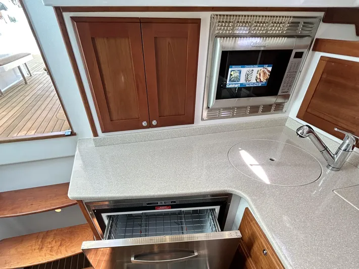  Yacht Photos Pics 2014 Back Cove Downeast 37 yacht kitchen with microwave, sink, and dishwasher.