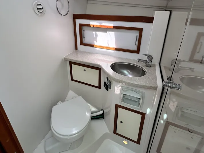  Yacht Photos Pics 2014 Back Cove Downeast 37 yacht bathroom with sink, toilet, and storage cabinets.