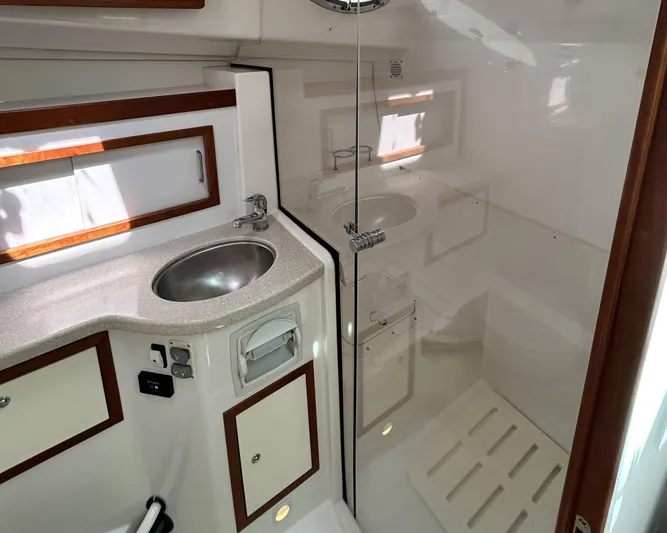  Yacht Photos Pics 2014 Back Cove Downeast 37 yacht bathroom with sink and shower, featuring wood accents.